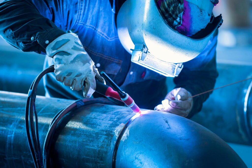 Welder welding pipe using certified welding methods