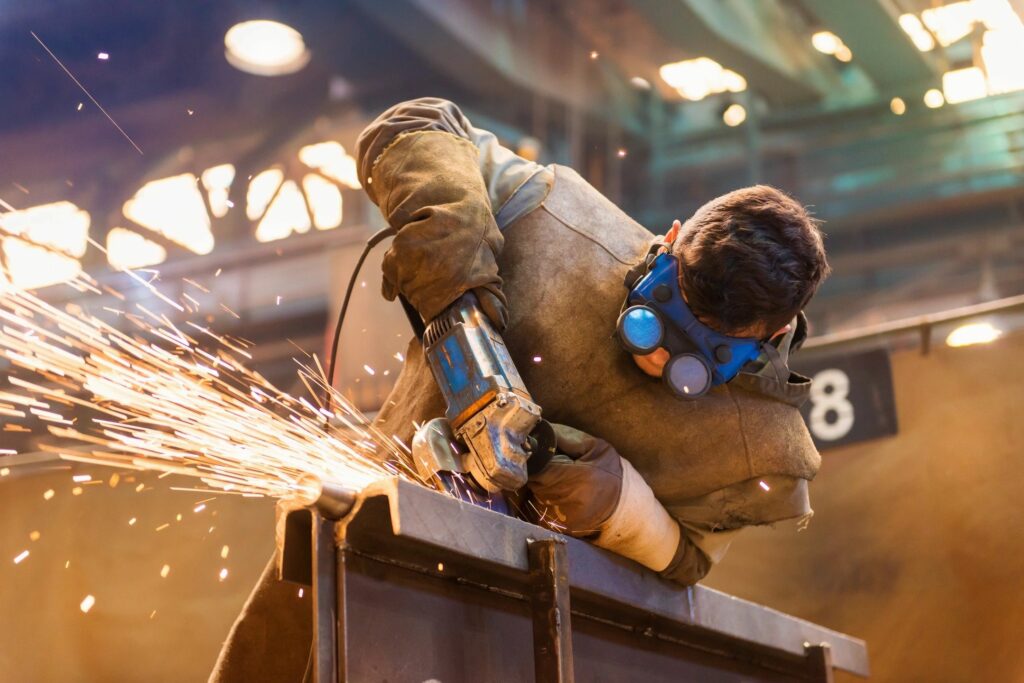 Welder performing fabrication on metal product